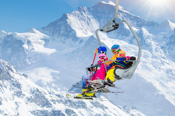 Family in a ski lift in the mountains