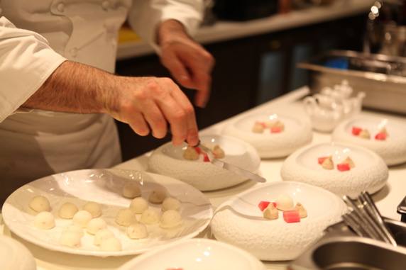 Michelin chef plating up food in a restaurant